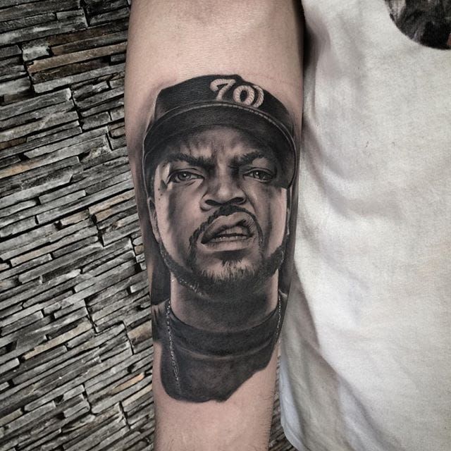 Psychedelic style Ice Cube portrait tattoo on the right