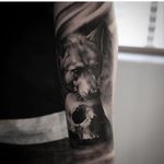 Soft black and grey wolf and skull tattoo by Jonas Bødker. #blackandgrey #realism #JonasBødker #wolf #skull