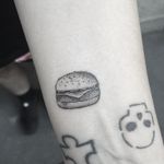 Miniature burger tattoo by Jessica Aaron #JessicaAaron #fineline #blackandgrey #monochrome #finelineblackandgrey #miniature #burger