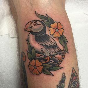 Puffin and yellow flowers tattoo by Lewis S Davies. #neotraditional #flowers #puffin #bird #LewisSDavies