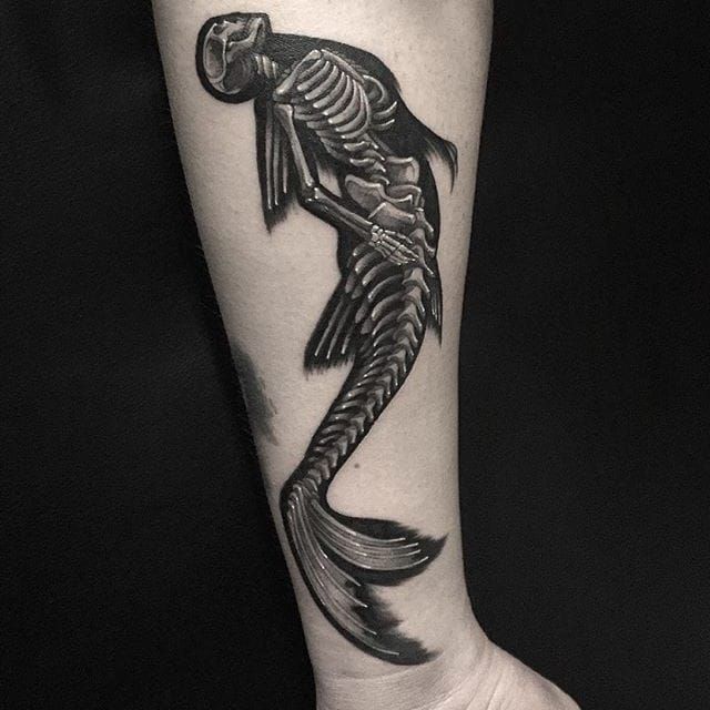 Surrealist mermaid holding a ram skull tattoo on