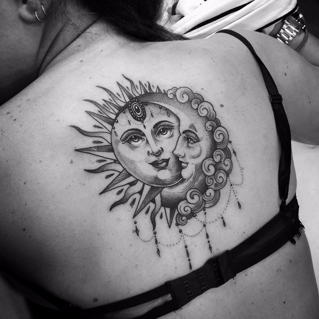 Sun and moon tattoo on the upper back
