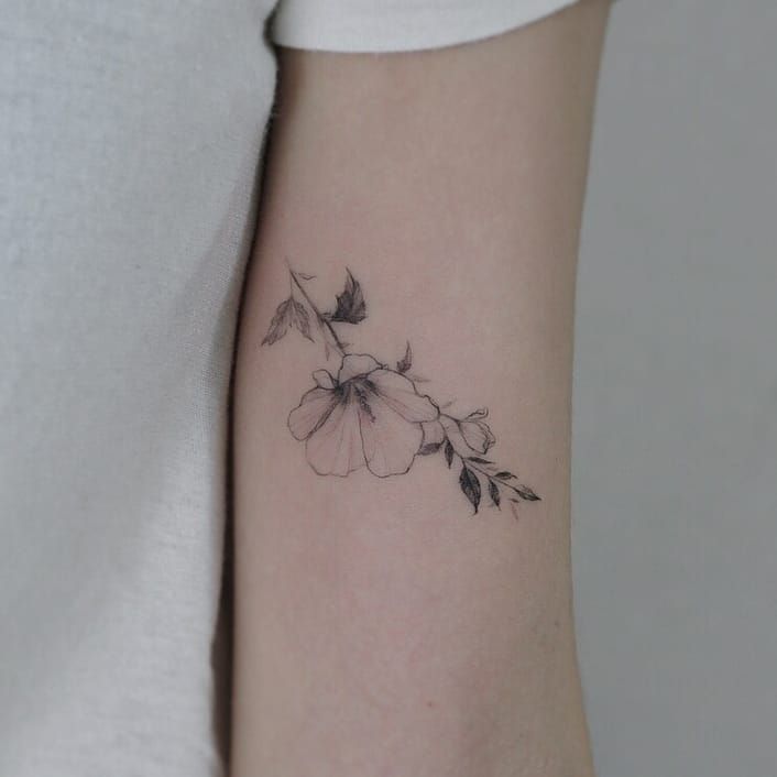 Fine line magnolia flower tattoo on the left inner