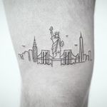 Cityscape tattoo by Rob Green #RobGreen #newyorktattoo #linework #fineline #minimal #small #statueofliberty #ladyliberty #nyc #newyorkcity #ChryslerBuilding #empirestatebuilding #bridge #birds #Hudsonriver