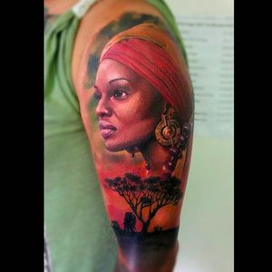 Amazing colored portrait of an African woman by Peter Tattooer. #PeterTattooer #portraittattoo #realistic #africangirl #colorportrait #portrait #realism #african