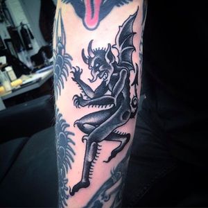 Clean winged demon filler tattoo by Simon Erl. #SimonErl #blackwork #traditionaltattoos #blacktattoos #DHARMAtattoo #demon #devil #winged