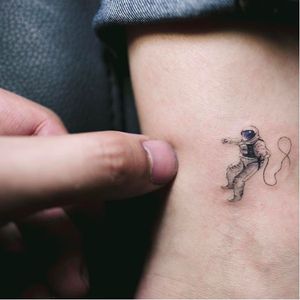 Mini astronaut tattoo by Sol Tattoo. #soltattoo #tattooistsol #minitattoo #macrotattoo #finelinetattoo #spacetattoo #spacemantattoo #astronaut #astronauttattoo