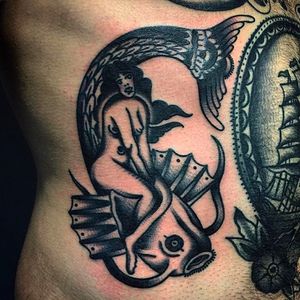 A folky looking pin-up on a fish. Awesome tattoo by Rodrigo Garcia Delgadillo. #RodrigoGarciaDelgadillo #pinup