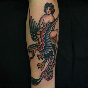 Awesome winged serpent with a pin-up. #AndrewMcleod #traditionaltattoo #bird #woman #snakebird #pinup