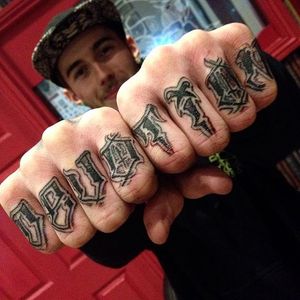 'Devotion' lettering knuckle tattoos by Ben O'Carroll. #script #lettering #BenOCarroll #typography #devotion #knuckles #knuckletattoo