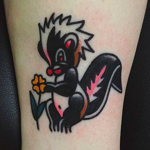 Skunk and a flower. Cute little piece by Joshua Marks. #JoshuaMarks #ETS #traditionaltattoos #boldtattoos #classic #skunk