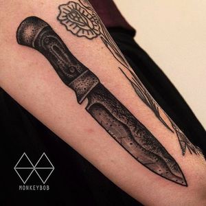 Incredible detail work on the blade of this knife tattoo by Monkey Bob. #MonkeyBob #knife #black #tattoo