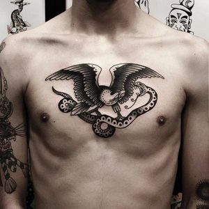 Eagle vs Snake chest tattoo by Andre Albuquerque. Photo: @albvquerque #andrealbuquerque #black #tattoo #eagle #snake #traditional
