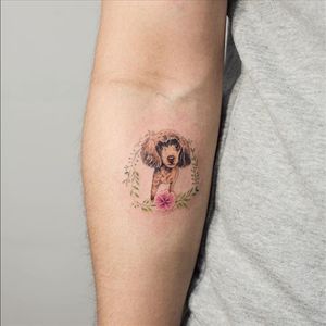 A lovely minute Poodle bordered in floral work from Sol Tattoo's (IG—soltattoo) portfolio. #adorable #micropuppies #minature #realism #SolTattoo