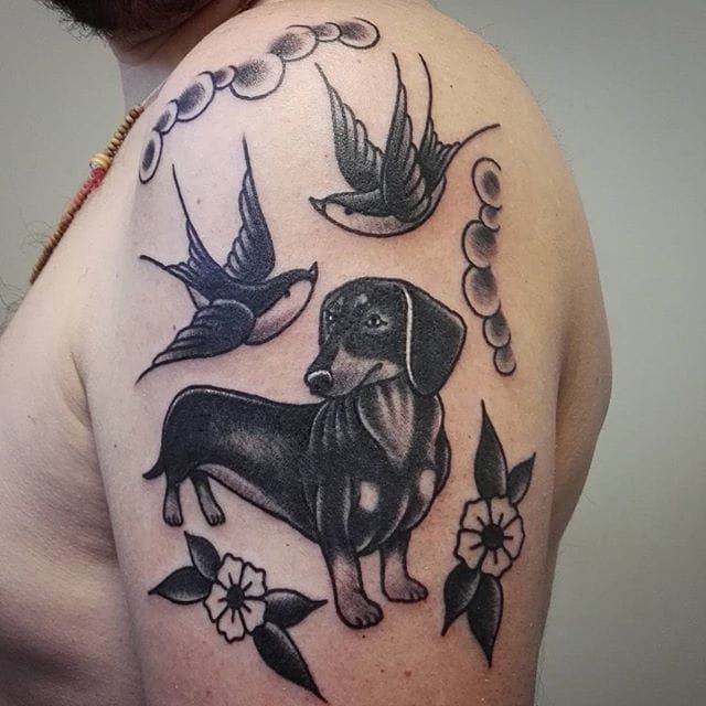 Tattoo uploaded by Stacie Mayer • Blackwork traditional dachshund tattoo by  Giusva Grignani. #traditional #blackwork #dog #bird #flower #swallows # dachshund #GiusvaGrignani • Tattoodo