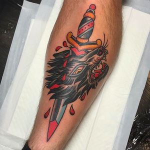 Awesome looking wolf head with a dagger. Tattoo by Andrew Mcleod.  #AndrewMcleod #traditionaltattoo #traditional #dagger #wolfhead #wolf #animal