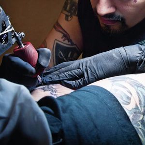 Tattoo artist tattooing a customer. #Tattooing #TattooArtist