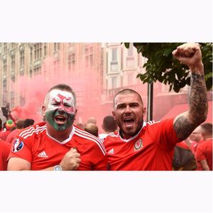 Excited tattooed welsh men celebrating in France. By Joe Giddens/PA