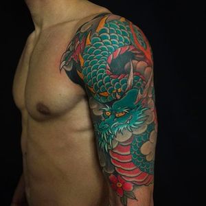 Awesome dragon half sleeve with sakura. Tattoo by Luciano Vazquez. #LucianoVazquez #JapaneseStyle #irezumi #japanesetattoo #dragon #ryu #sakura