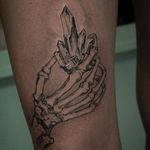 Skeleton hand and crystal tattoo by Hori Benny #HoriBenny #jeweltattoos #blackandgrey #linework #dotwork #illustrative #crystal #gem #jewel #sparkle #skeleton #hand #bones #death #tattoooftheday