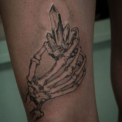 hand holding crystal ball tattoo