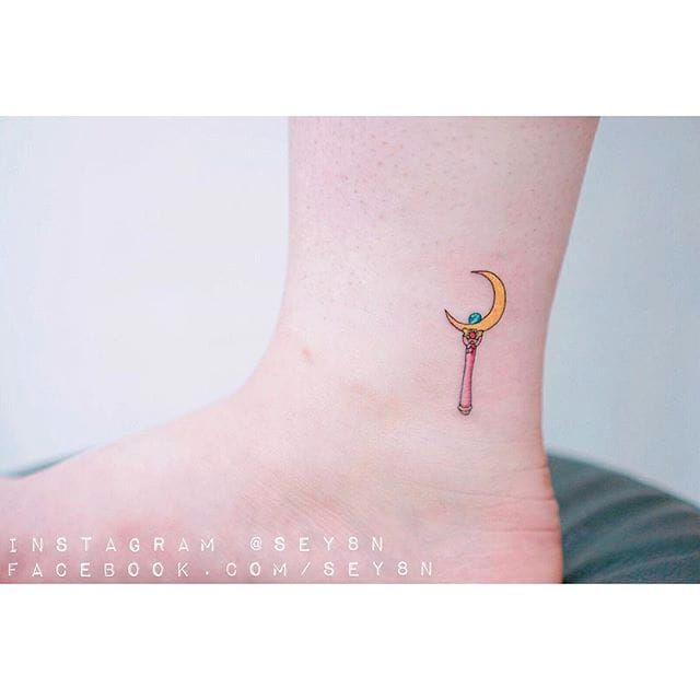 Minimalist flower moon tattoo on the wrist