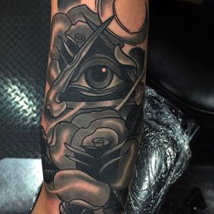 Tatuaje negro y gris de una rosa y el ojo que todo lo ve.  Atrevido tatuaje de Emilio Saylor.  #EmilioSaylor #rosa #ojos que aluden #gris negro