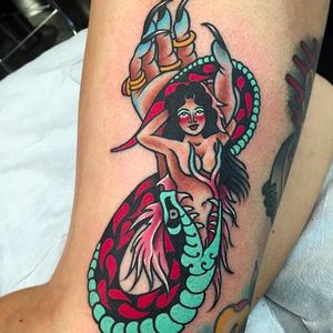 Serpent and the hand swallowing a pinup, crazy solid tattoo done by Paul Nycz. #PaulNycz #traditional #neotraditionaltattoo #coloredtattoo #serpent #hand #woman