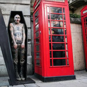 Awesome shot by Casey Gutteridge of Zombie Boy in a coffin next to a phone booth. #heavilytattooed #model #photography #RickGenest #ZombieBoy