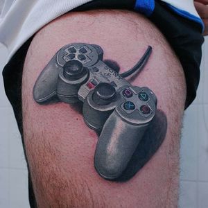 PlayStation-inspired tattoo by Stefano Gollinelli. #colorrealism #realistic #playstation #sony #nostalgia #videogames #retro #childhood #controller