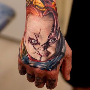 Chucky hand tattoo by Khan. #Chucky #ChildsPlay #horror #doll #handtattoo #realism #colorrealism #Khan