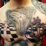 Surreal clock and chess game tattoo by Tommy Montoya #tommymontoya #blackandgrey #realism #realistic #surreal #clock #chess #boardgame #game #king #queen #pawn #time