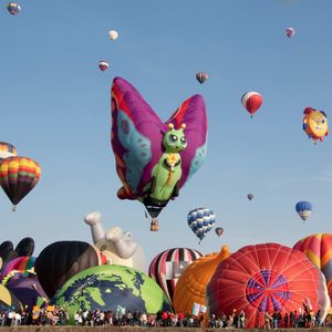 A photograph of a bunch of hot air balloons at a festival. #hotairballoons