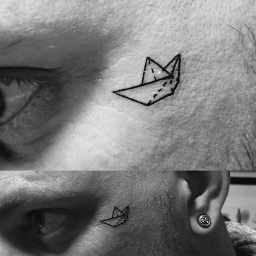 Paper boat tattoo by Laura Underskin. #microtattoo #subtle #minimalist #paperboat #face #minimalistic
