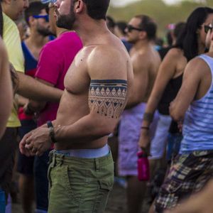 Festival fan showing off his geometric armband tattoo, photo by Rodrigo Zaim and Lucas Jacinto #tomorrowlandbrazil #festival #tattoostyle #RodrigoZaim #LucasJacinto #blackwork
