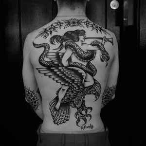 Falcon, Snake and lady with the trumpet, awesome back piece by Rich Hardy. #RichHardy #blackwork #traditionaltattoos #classictattoos  #americana #falcon #snake #woman #backpiece