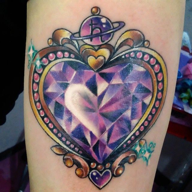 Tiny minimalistic purple heart tattoo done on the