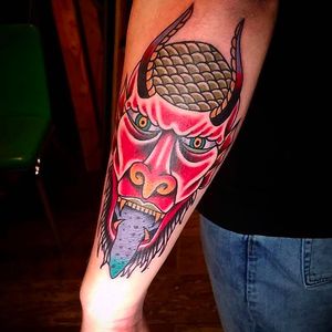 Funky looking demon head tattoo by Douglas Grady. #DouglasGrady #traditionaltattoo #coloredtattoo #brightandbold #demonhead #forearmtattoo