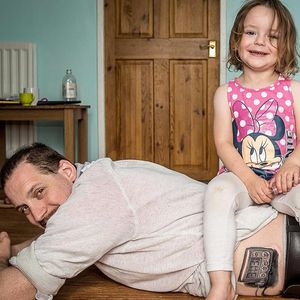 Abagail sitting on Alan's back with her insulin pump in hand. #dad #daughter #diabetes #diabetic #family #heartwarming #inspirational #insulinpump #love #blackandgrey #blackandgreyrealism