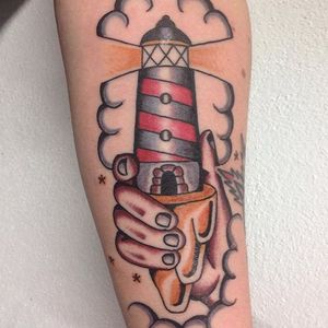 Holding the lighthouse, by Lantattooer #Lantattooer #lighthousetattoo #traditionaltattoo
