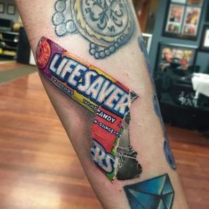 Get a hole lot more out of life with a Lifesavers tattoo. Tattoo by Pony Lawson. #realism #colorrealism #candy #lifesavers #PonyLawson