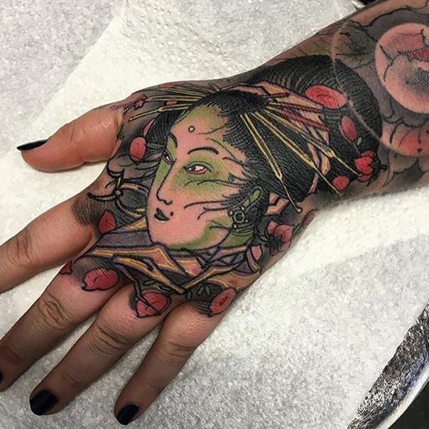 Asian female face on hand by Little Dragon TattooNOW