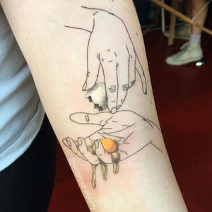 Egg-cellent tattoo by Shannon Perry #ShannonPerry #foodtattoos #color #blackandgrey #linework #egg #yolk #hands #realism #realistic #hyperrealism #illustrative #minimal #strange #surreal #tattoooftheday