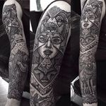 Awesome sleeve tattoo of a lady wearing a wolf cowl, tattoo work by Paul Davies. #pauldavies #blacktattoo #illustrativetattoo #geometrictattoo #dotstolines #wolf #girlhead