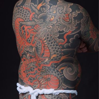 Dragon protector by Bunshin Horitoshi #BunshinHoritoshi #Japanese #dragon #fire #clouds #color #scales #horns #chrysanthemum #blackandgrey #tattoooftheday