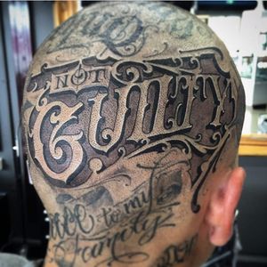 A head banger that reads "not guilty" by Sam Taylor (IG—samtaylortattoos). #blackandgrey #hollowedVictorian #lettering #ornate #SamTaylore #script #typography