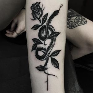 Snake and rose tattoo by Mike Adams #MikeAdams #besttattoos #blackwork #linework #dotwork #snake #reptile #rose #flower #leaves #tattoooftheday