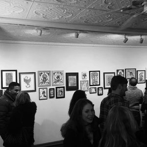 Partygoers take in the art show at Eight of Swords. Photo by Katie Vidan