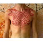 Red ink geometric chest tattoo by Grisha Maslov #redinktattoo #geometrictattoo #GrishaMaslov #abstracttattoo