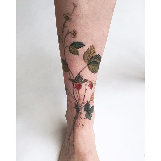 Watercolor strawberry tattoo on the wrist